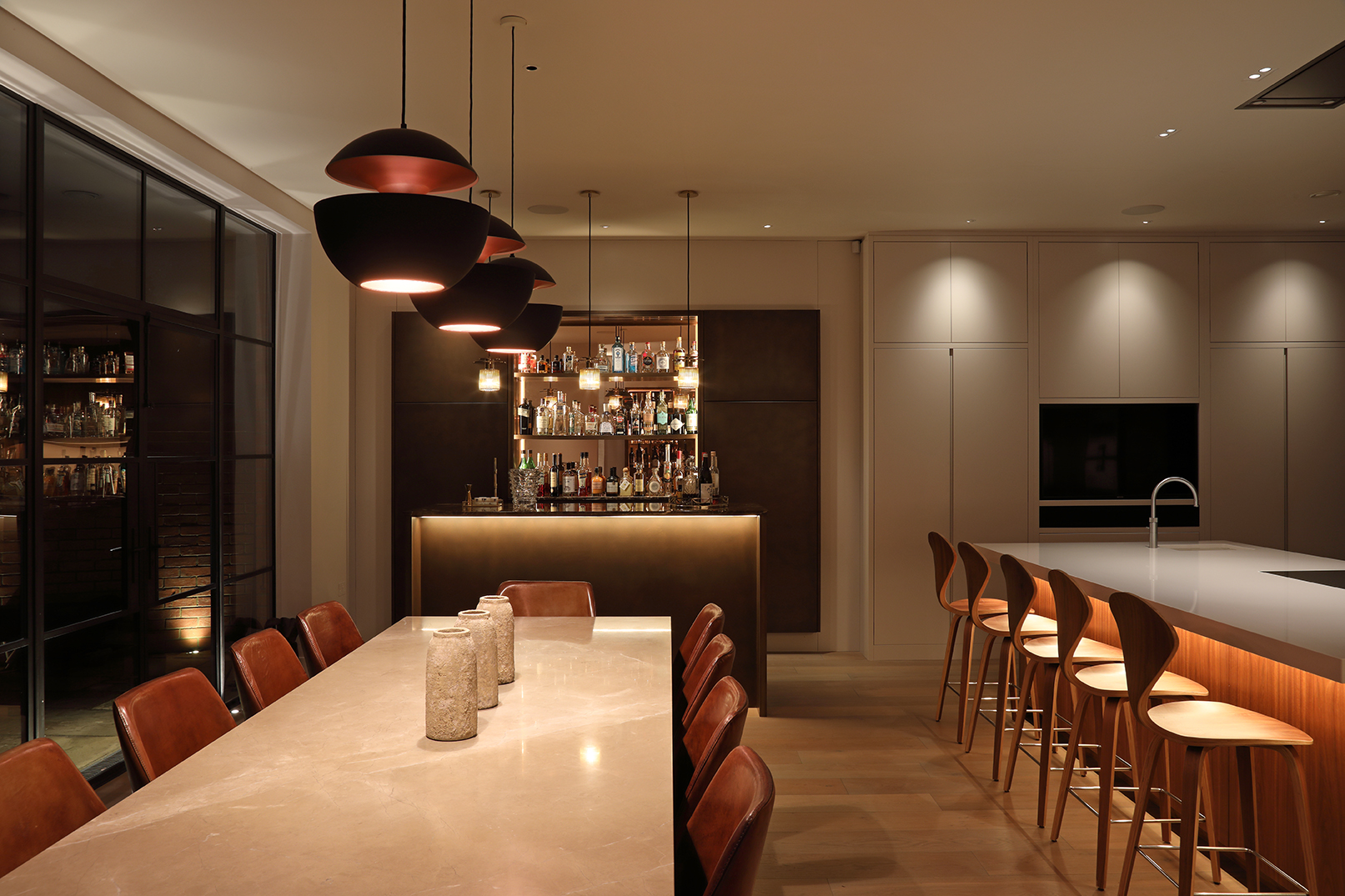 Bar lighting in kitchen at end of dining table with pendants