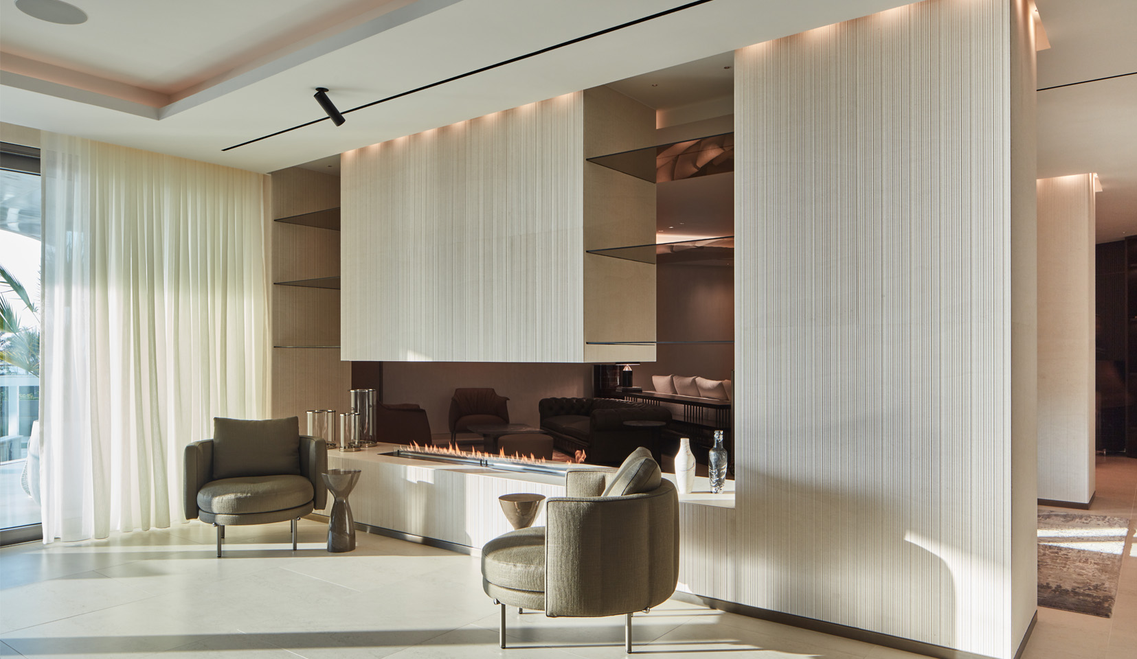 contemporary open plan fireplace with downlights to textured wall either side