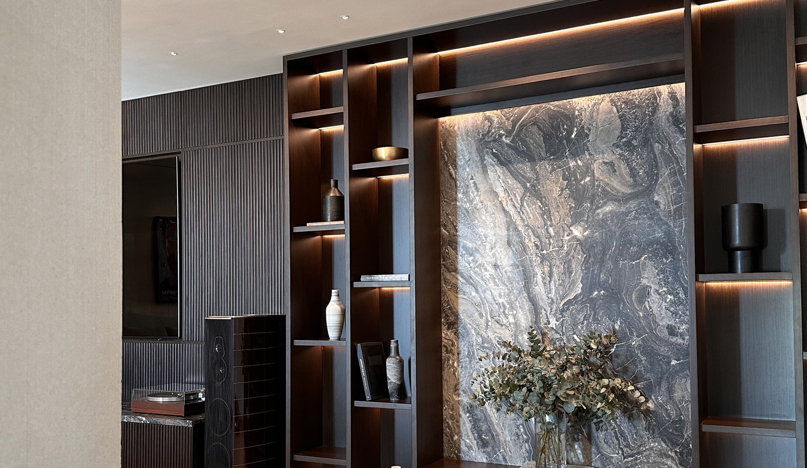 dark wood shelving unit with integrated lighting