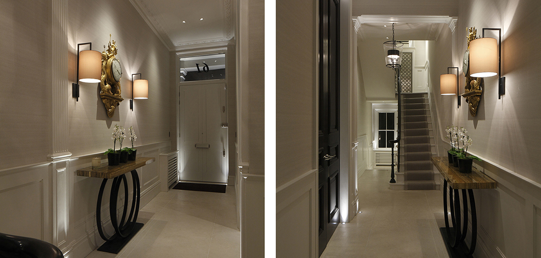 narrow townhouse hallway with wall lights and downlight to art