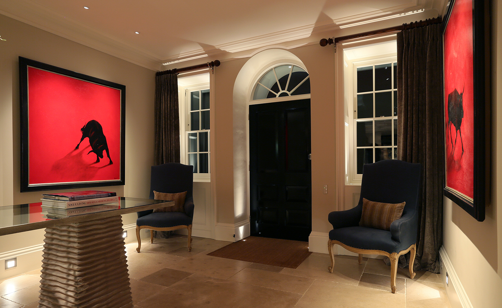 a hall with red art and a layered lighting scheme