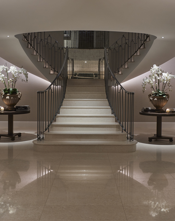 Luxury lighting scheme in dramatic hallway and sweeping staircase