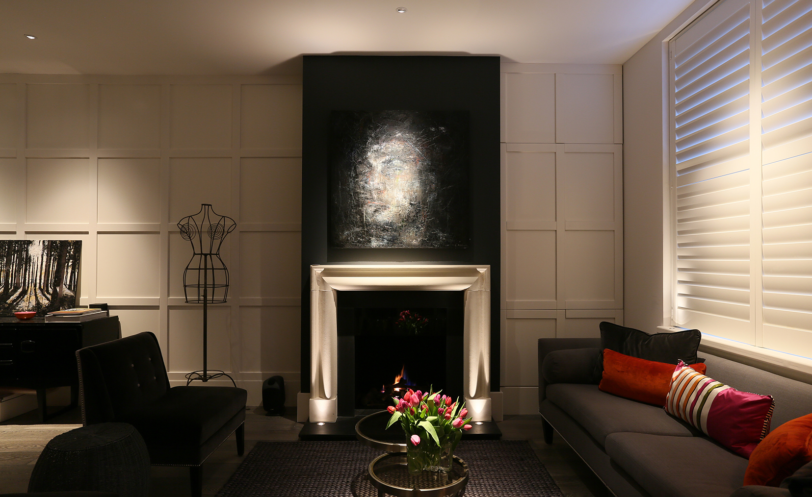 view to fireplace with pin spot beam from a downlight to the coffee table