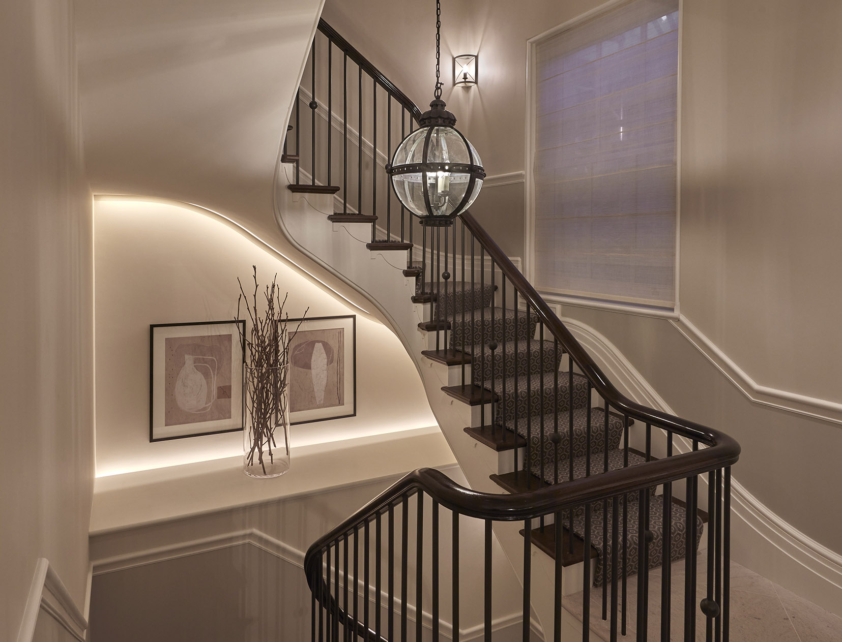pendant hanging in traditional staircase with linear led strip behind