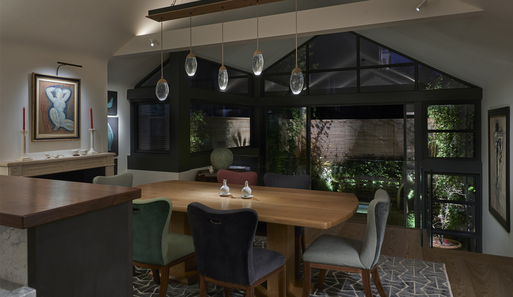 Dining room with open doors out onto lit garden