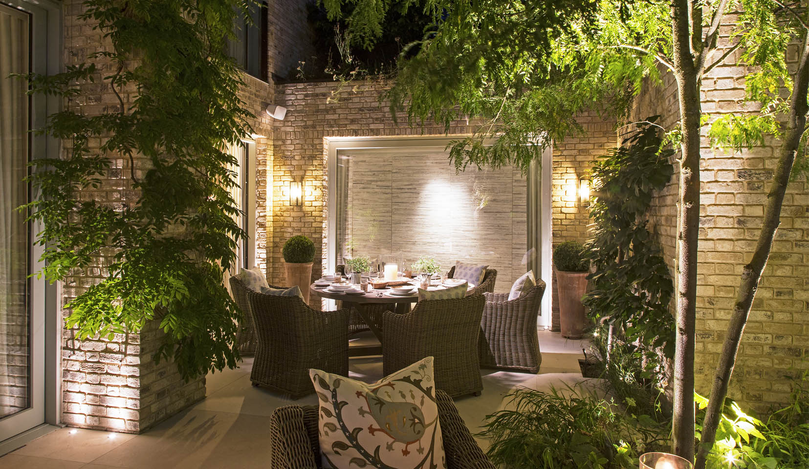 inviting alfresco dining scene with lanterns and uplit structure