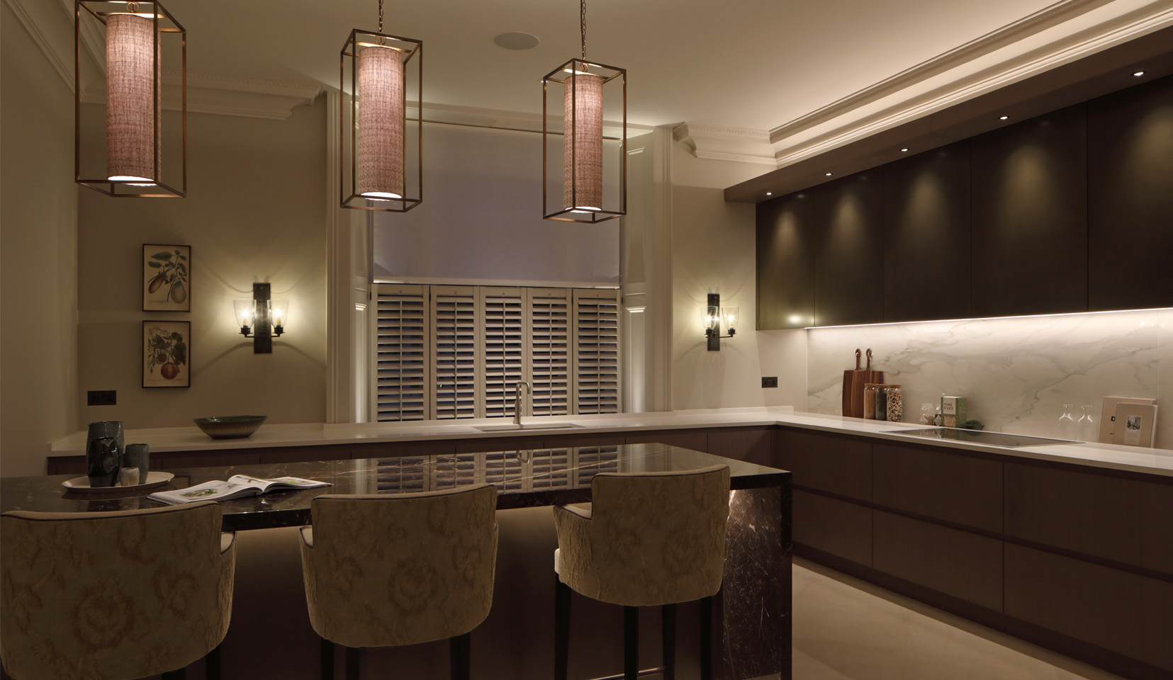 Kitchen with hanging pendants over island and under cupboard lighting