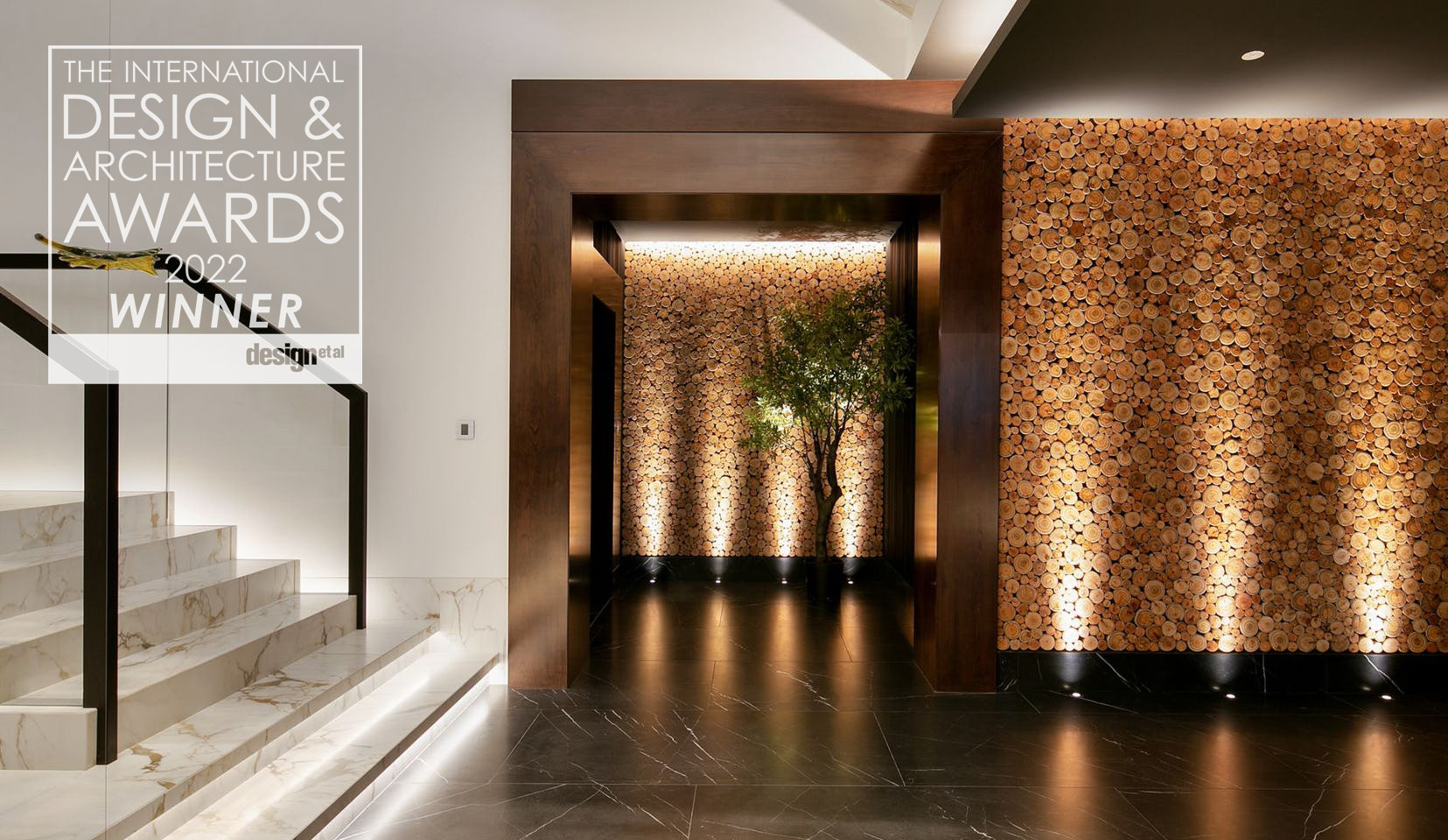 Stairs leading to uplit hallway with cork textured wall