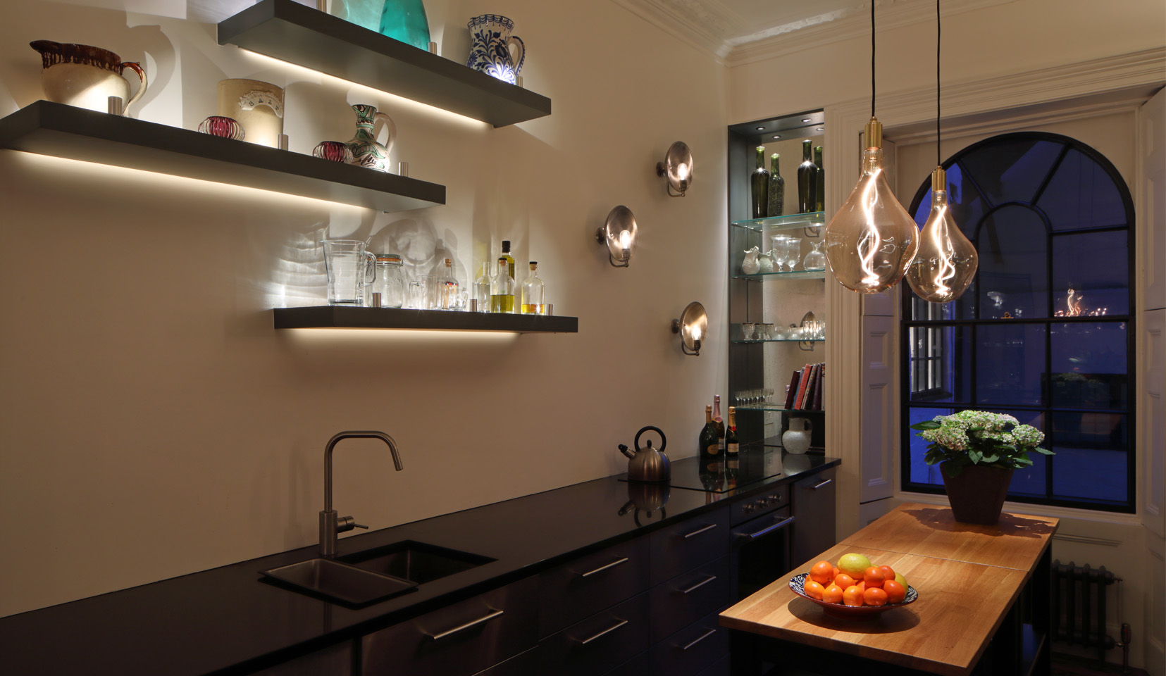 wall mounted shelves backlit with linear light in modern kitchen