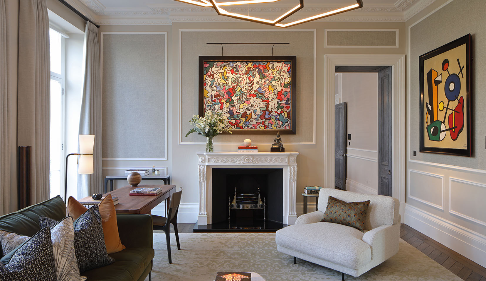 Picture light to artwork above fireplace is luxury living room