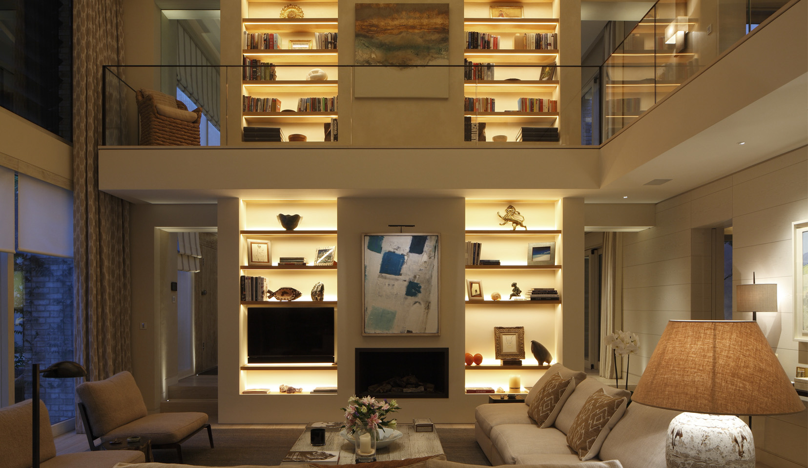 double height living area with lit joinery shelving