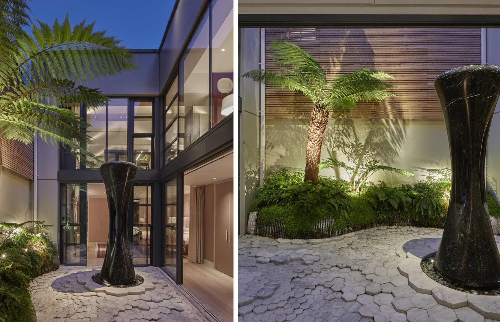 Courtyard with uplit sculpture and palm trees