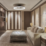 Large dressing room with downlit cupboards and bespoke wallpaper panels