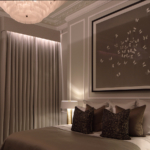 master bedroom with downlit curtains