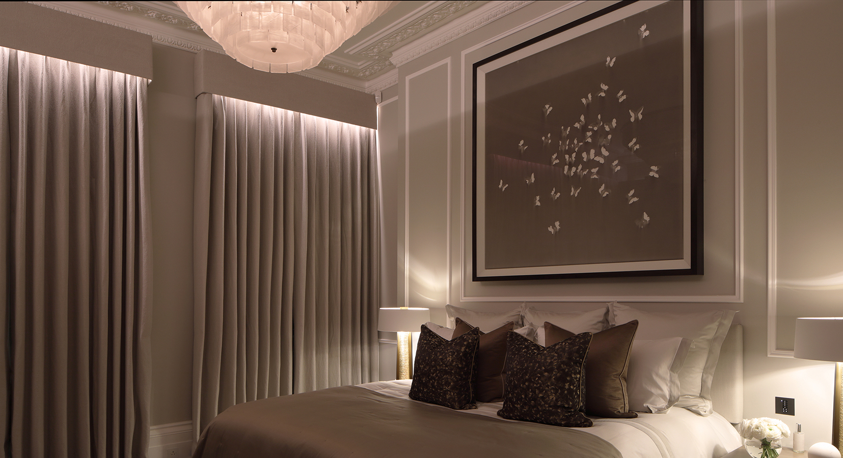 master bedroom with downlit curtains