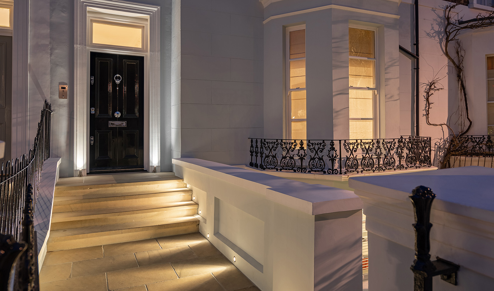 front door with uplight surround with lighitng down the path