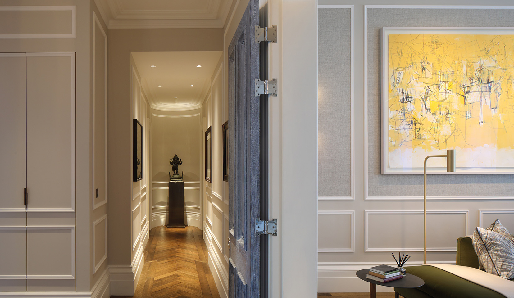 Hallway with sculpture at end lit from spotlights above