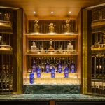 view of bar in london hotel with backlit sparkly glasses