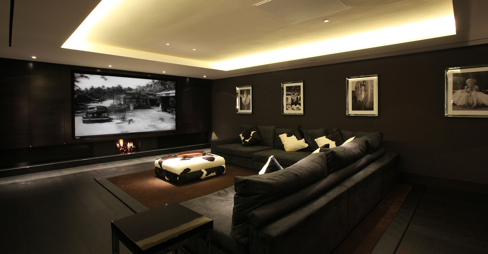 Large cinema room with coffer ceiling and downlight to coffee table