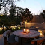 Courtyard garden with table and softly lit tulips
