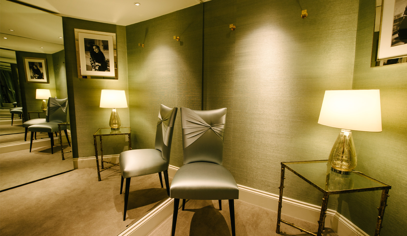 Elegant green dressing room within a clothing store