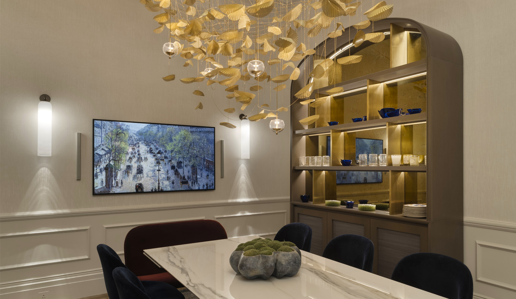Dining room with lit shelving unit and hanging gold pendant