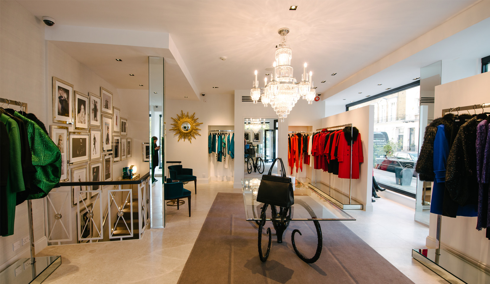 Interior of high end clothing showroom with women's clothing and accessories on display