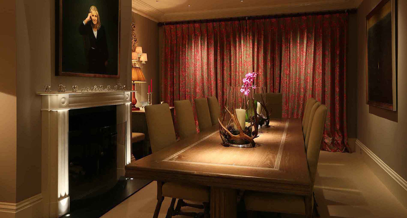 traditional dining room with lit artwork and curtains