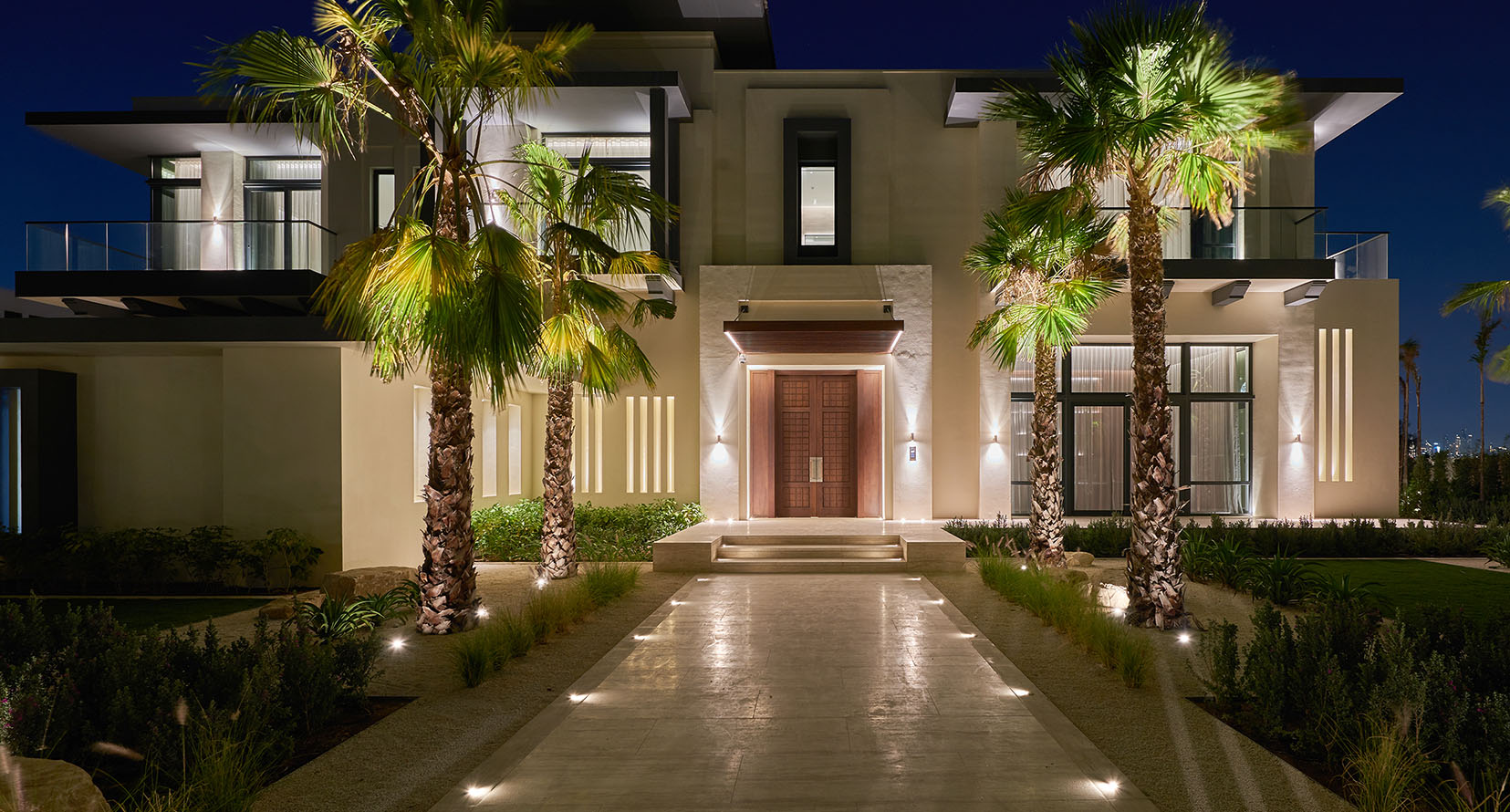 lit path to palm trees either side of front door