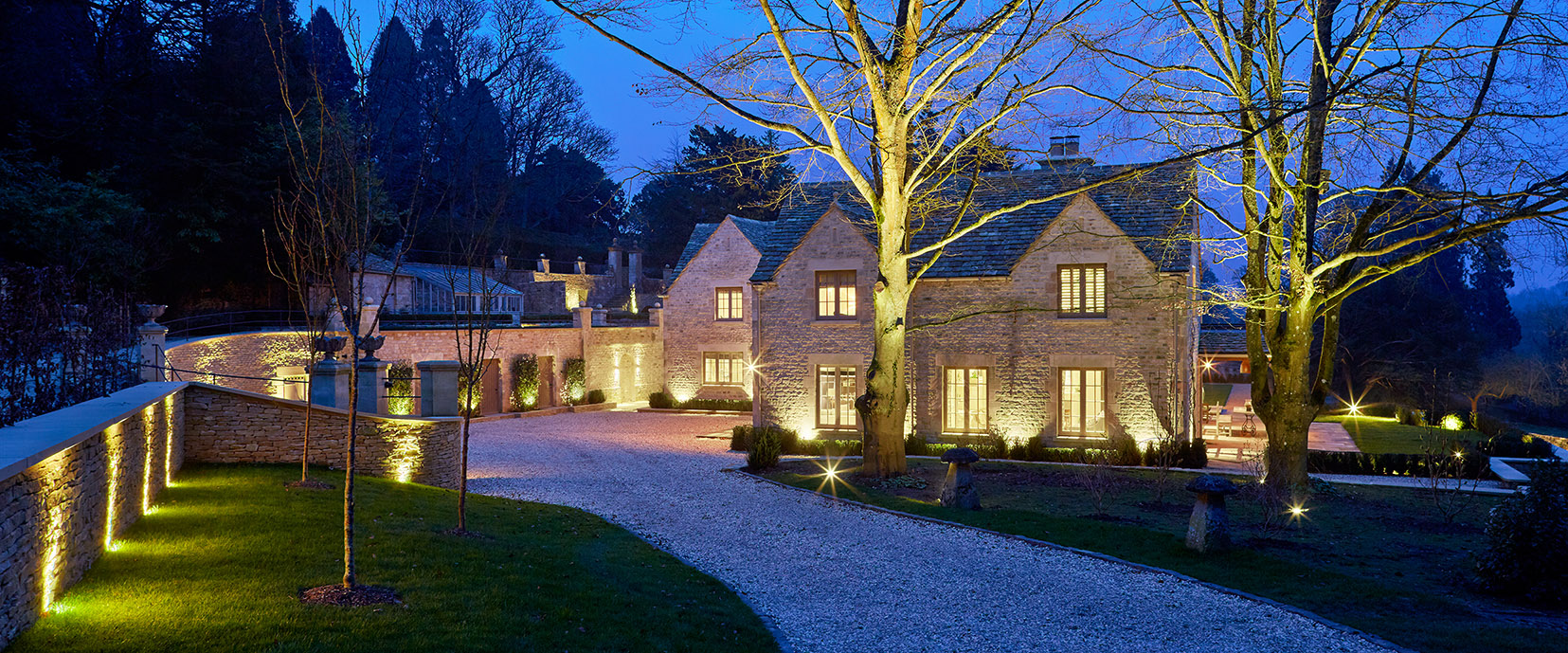 Driveway to country house with selective features lit