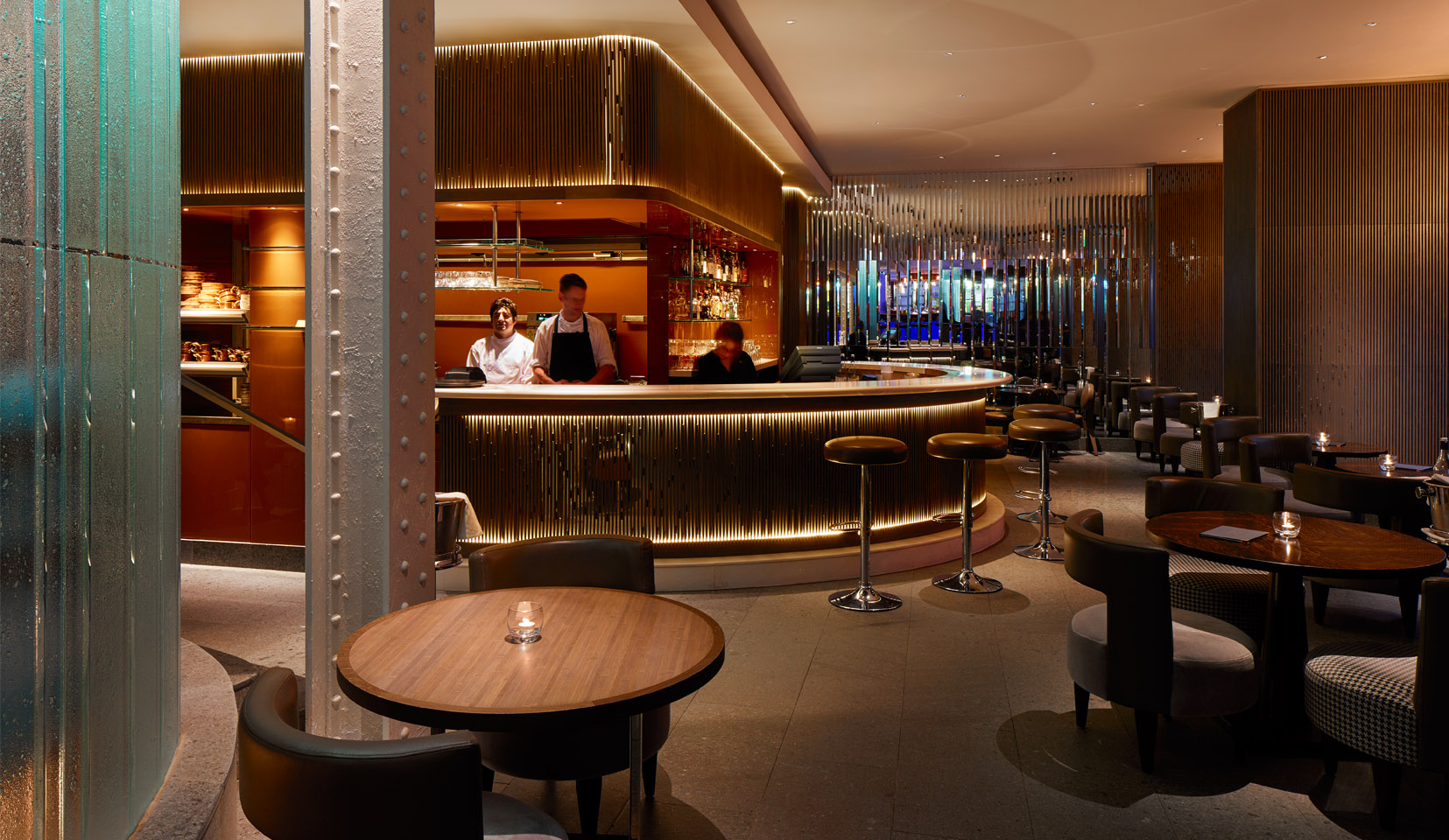 Luxury hotel bar with bar stools and small tables