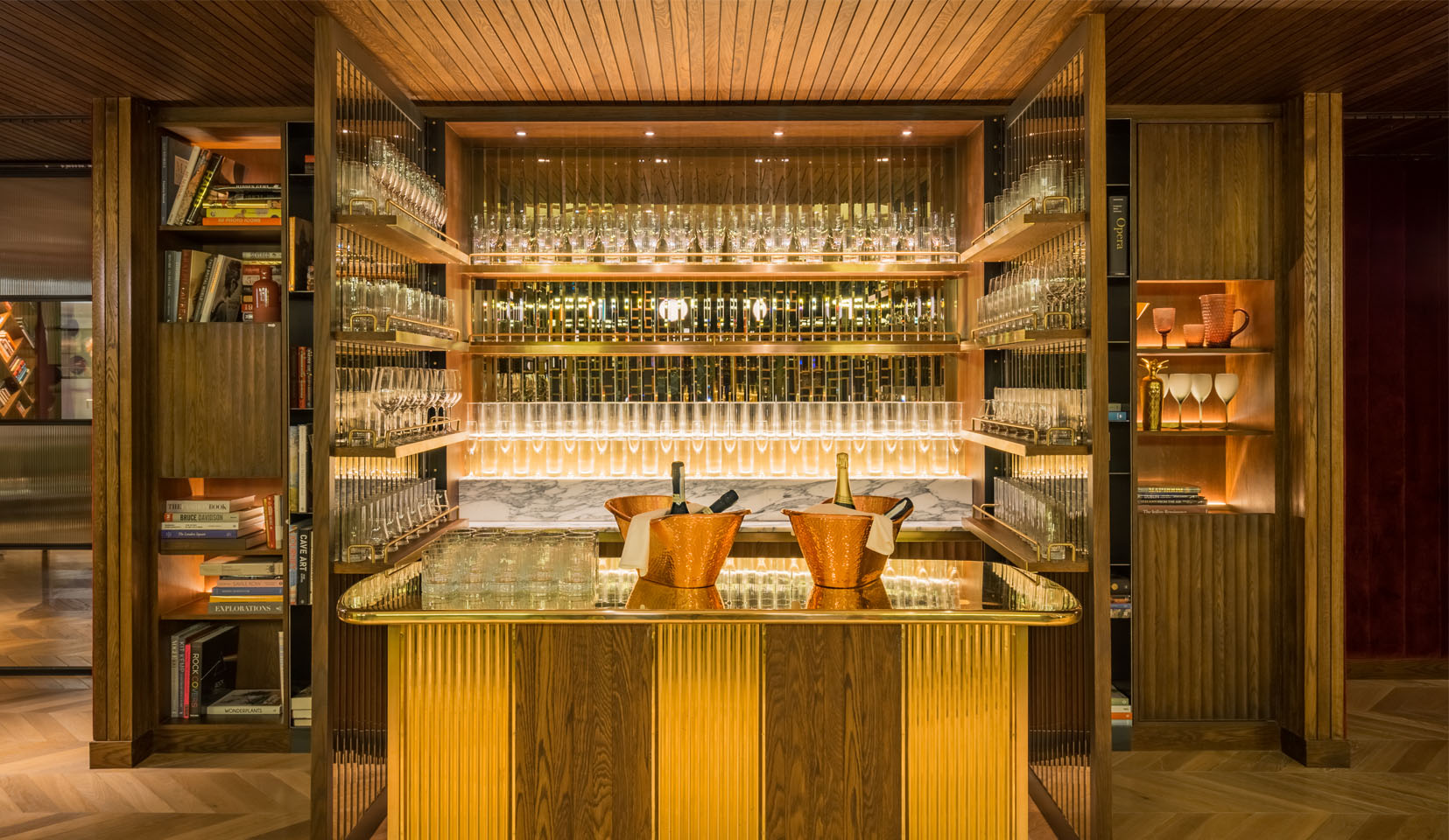 Backlighting to glass bottles in gold bar at Marylebone Hotel