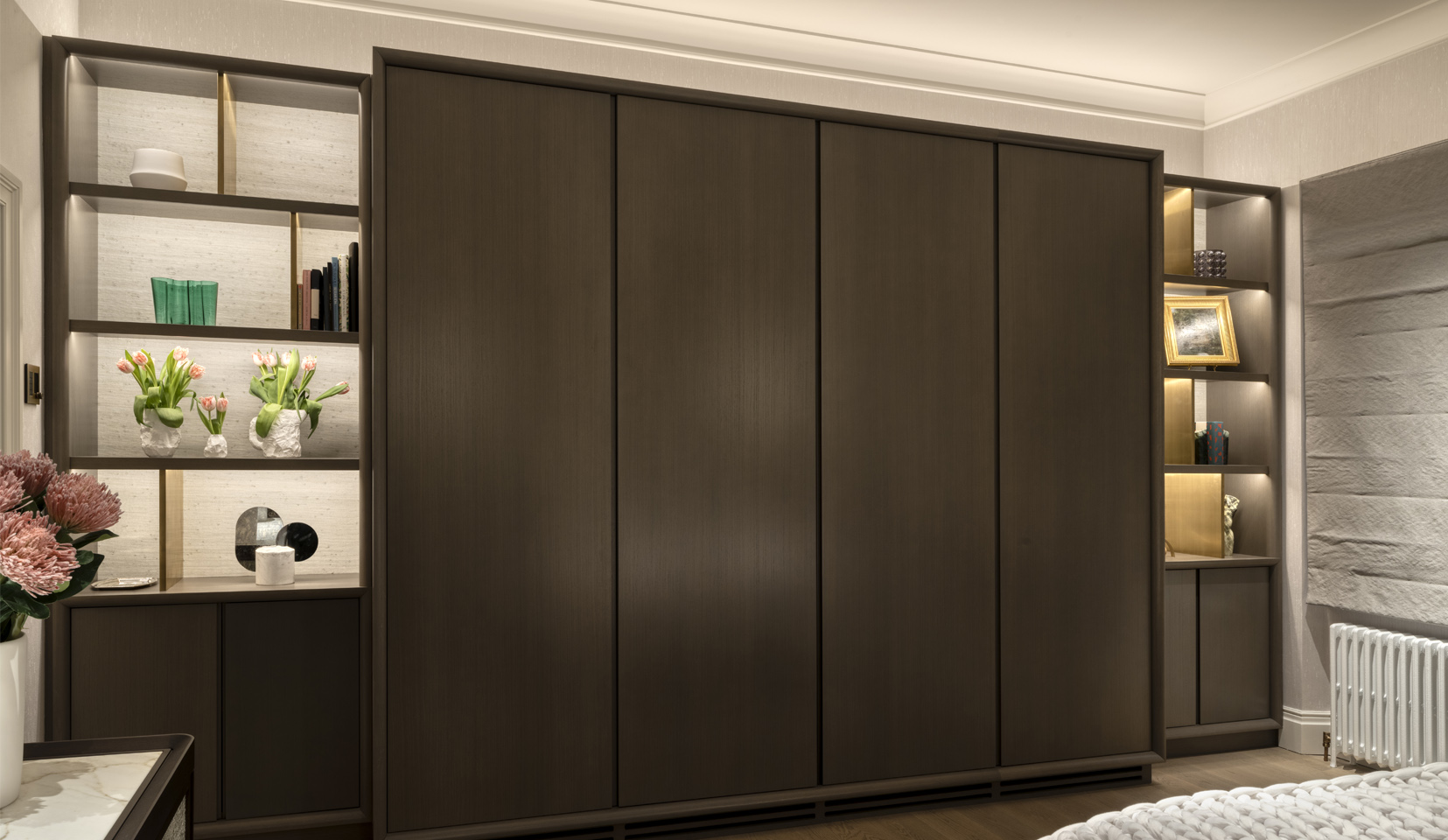 Bedroom wardrobes and joinery shelving unit lit with linear strip