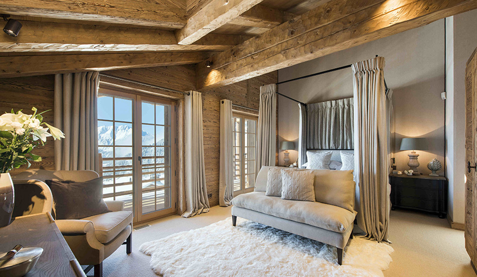 Cosy bedroom in chalet with view out onto mountains