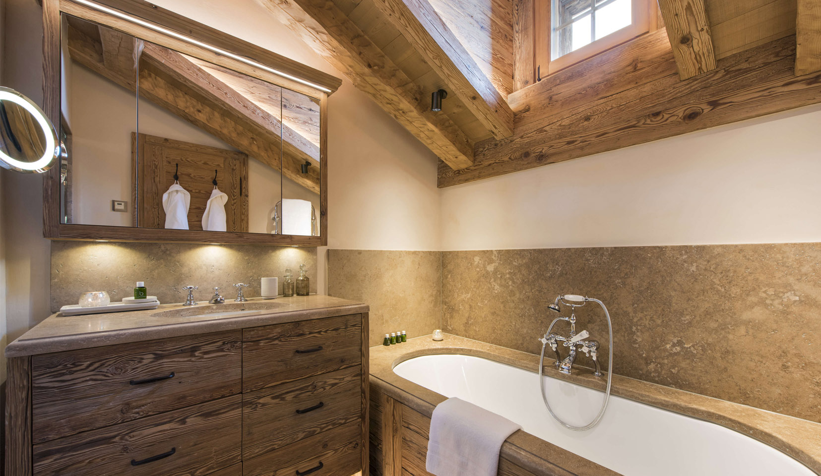 Chalet bathroom with wooden beams and bath