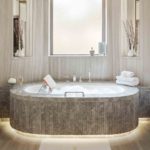 Floating marble bath with light surrounding the base