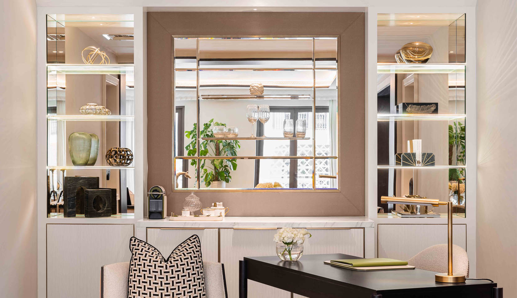 Shelving with mirrored backdrop and integrated joinery lighting