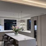 kitchen with long pendant over island and light in coffer