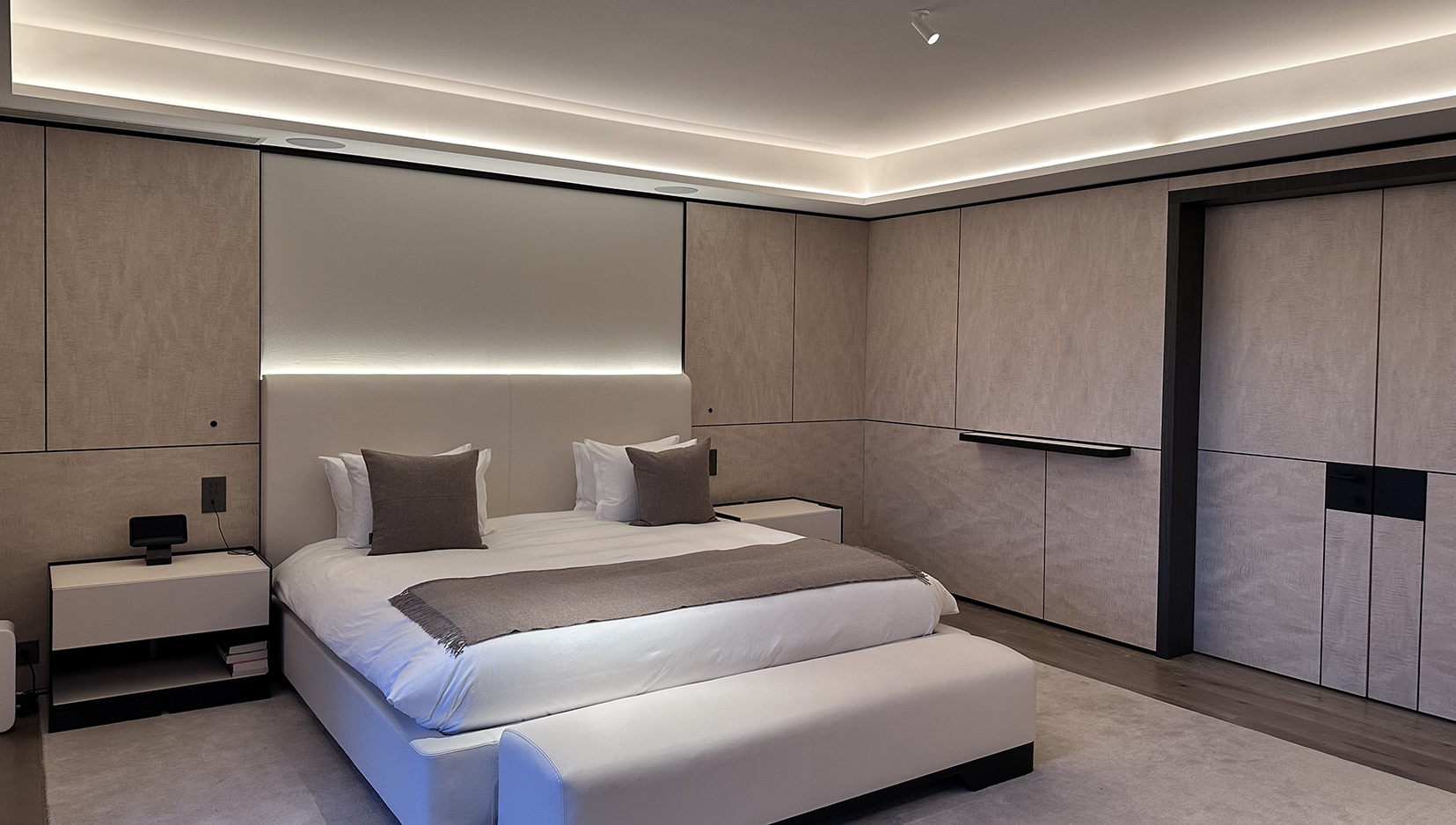 contemporary bedroom lighting with lit coffer and uplight behind bed
