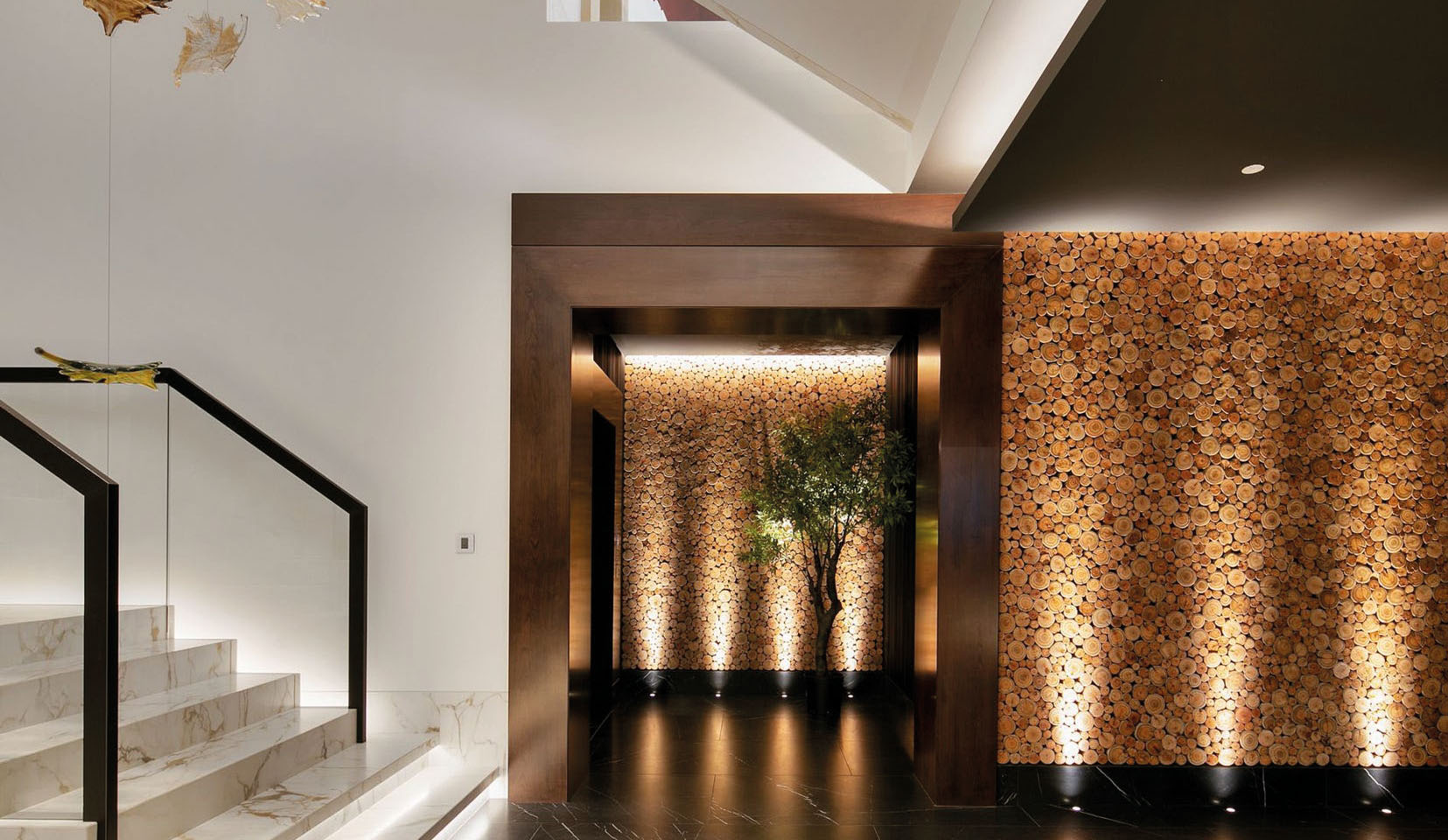 Hallway lit with John Cullen uplights to textured wall