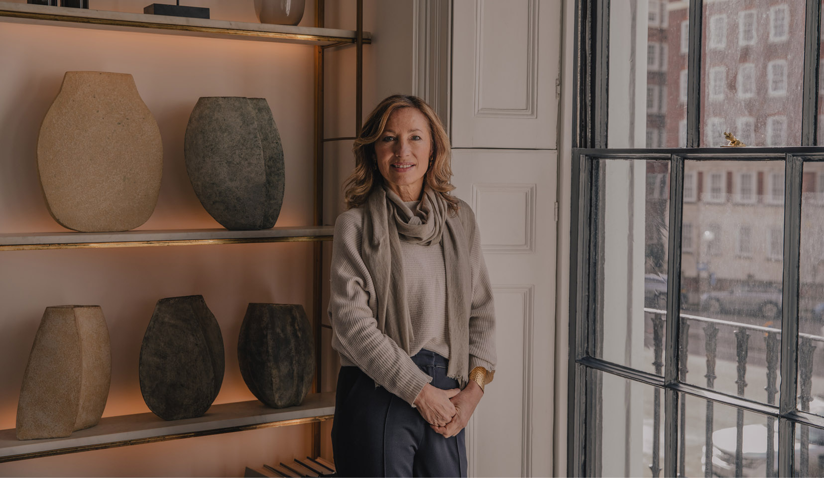 Sally Storey, lighting designer in her London home with backlit shelving